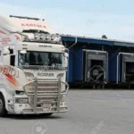 SEINAJOKI, FINLAND - AUGUST 12, 2017: Customized white Scania refrigerated transport truck of P Kantola Ky at the loading zone of a warehouse.